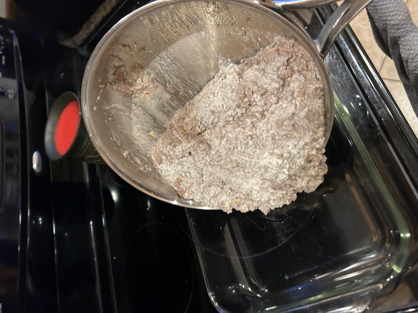 Pouring meat mixture into pan