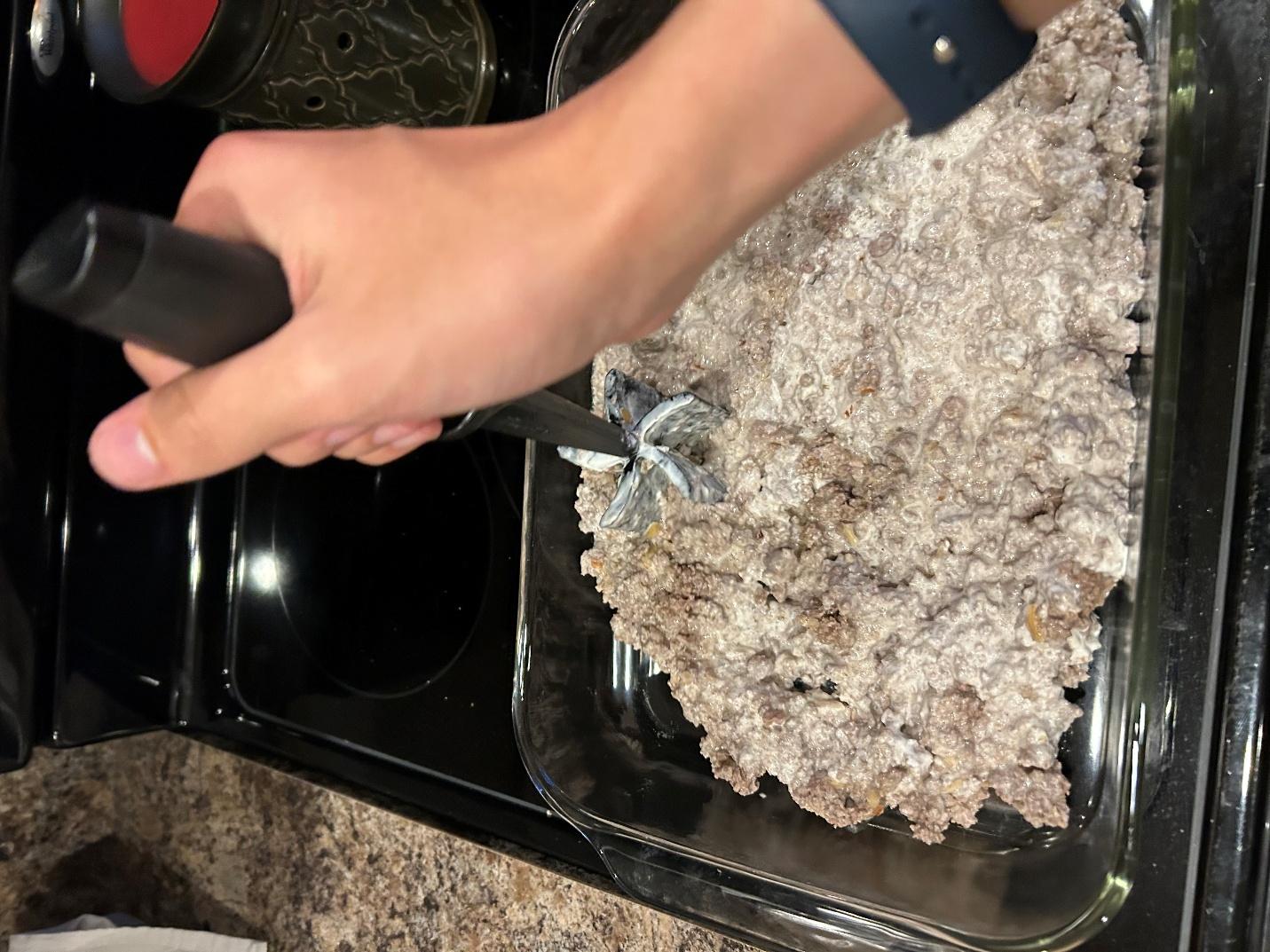 Spreading meat mixture evenly